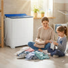 Portable washing machine with blue lid, shown in a laundry setting, ideal for daily laundry needs and easy mobility.