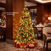 Pre-lit 6-foot green artificial Christmas tree with full branch tips and 600 LED lights for festive ambiance.