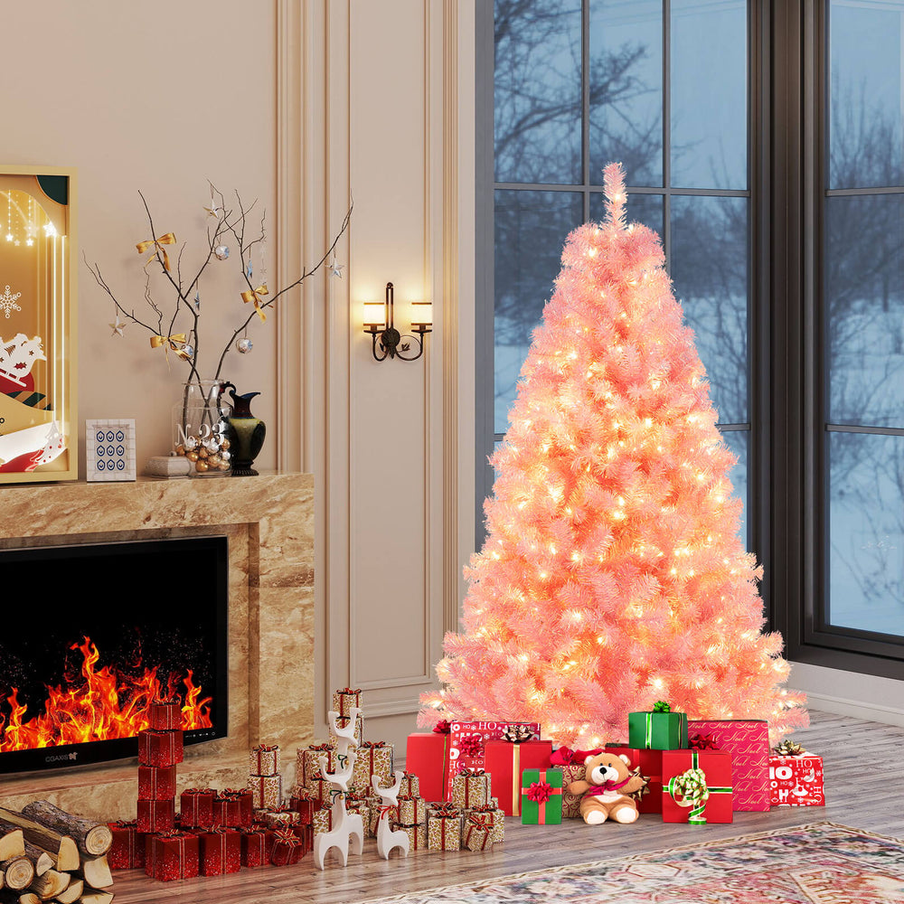 6ft pink pre-lit tinsel Christmas tree with warm white LED lights, surrounded by festive gifts and a cozy fireplace.