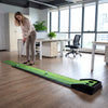 Indoor putting green mat with auto ball return, featuring a realistic surface and distance markings for practice.