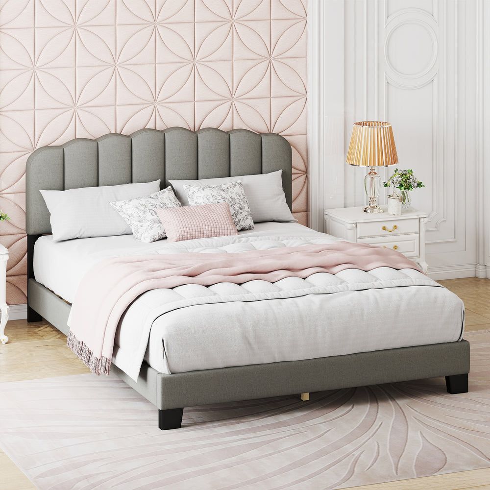 Queen size bed frame with a scalloped tufted headboard in gray, styled with a cozy blanket and decorative pillows for.