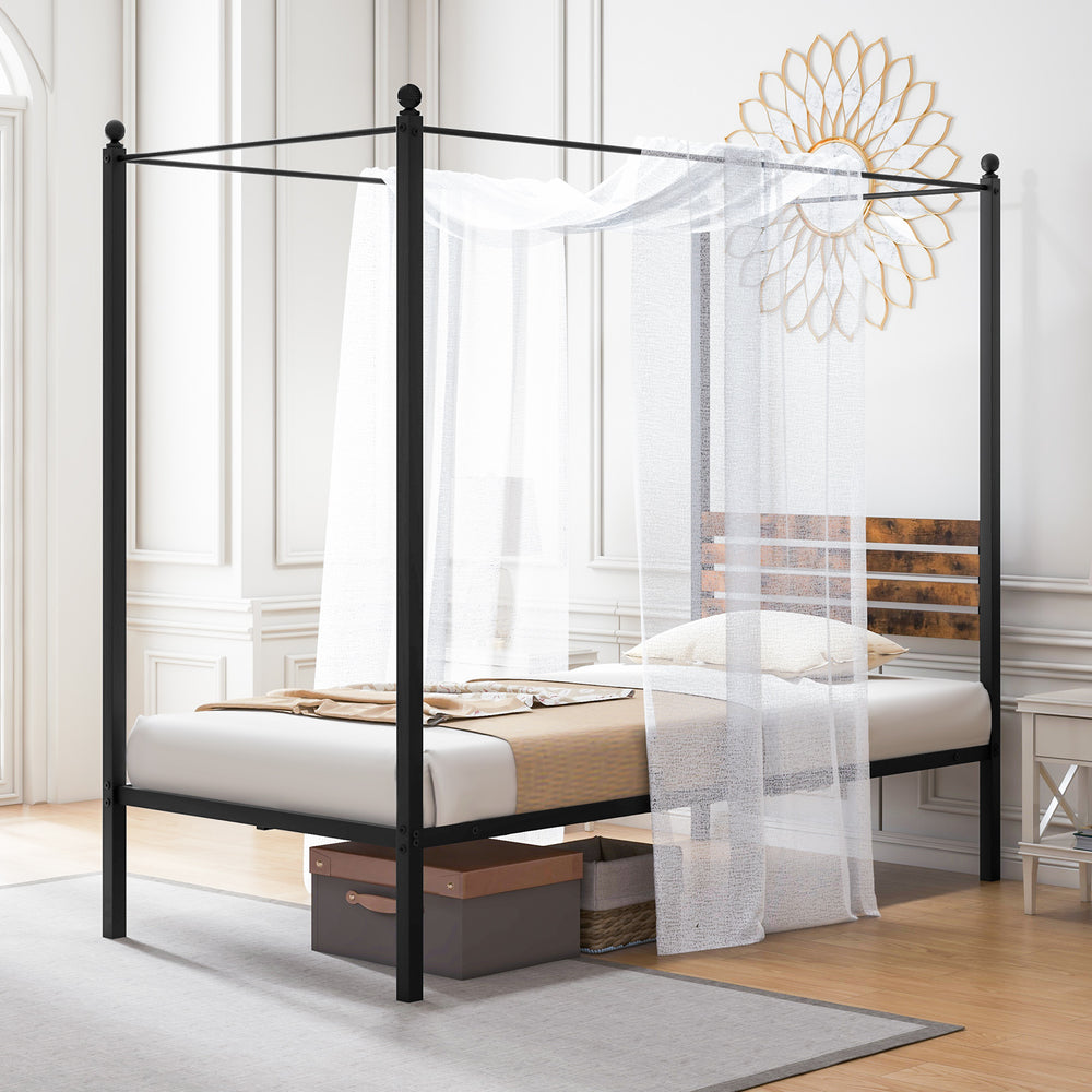 Queen size canopy bed frame in black metal with under bed storage and rustic headboard, styled with sheer curtains.
