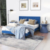 Queen size upholstered platform bed in blue styled with a plush blanket and decorative pillows, perfect for a cozy.