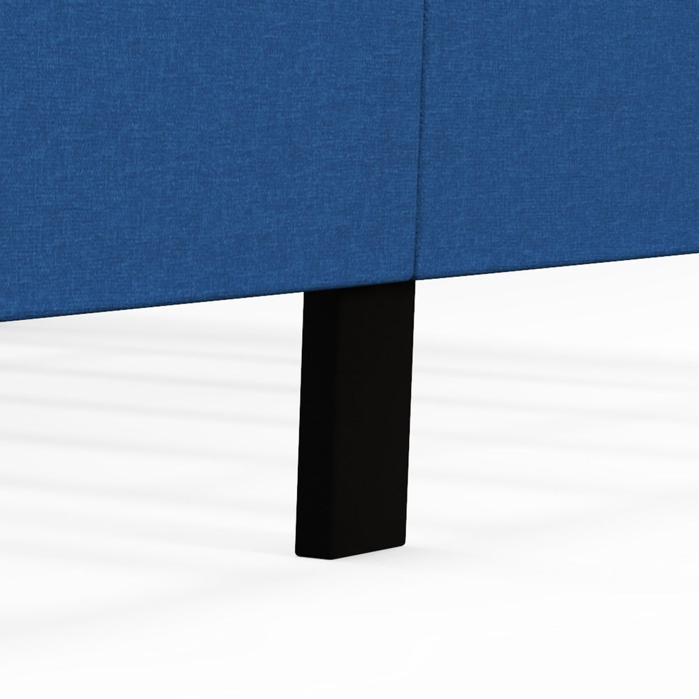 Close-up of the solid wood leg of a blue upholstered platform bed with button tufted headboard for enhanced stability.