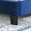 Close-up of the blue velvet platform bed leg with nailhead trim, offering sturdy support and stylish design for.