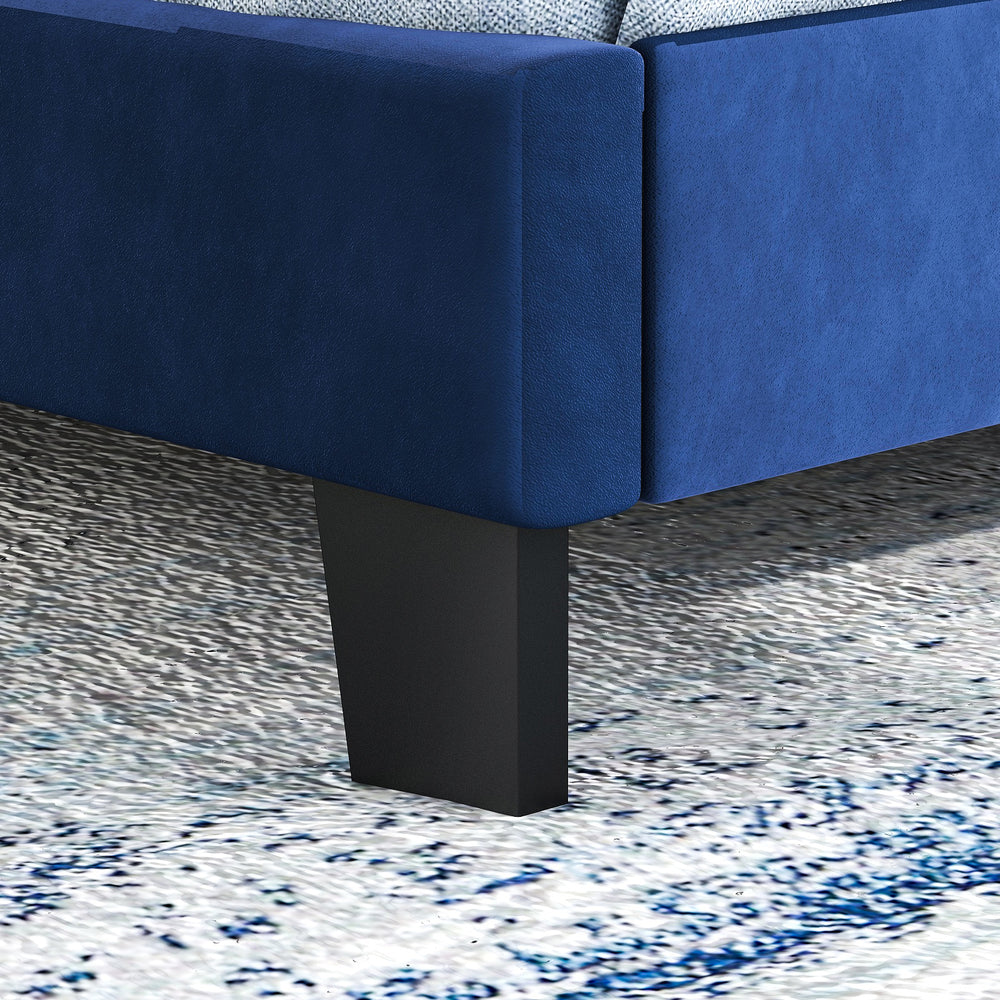 Close-up of the blue velvet platform bed leg with nailhead trim, offering sturdy support and stylish design for.
