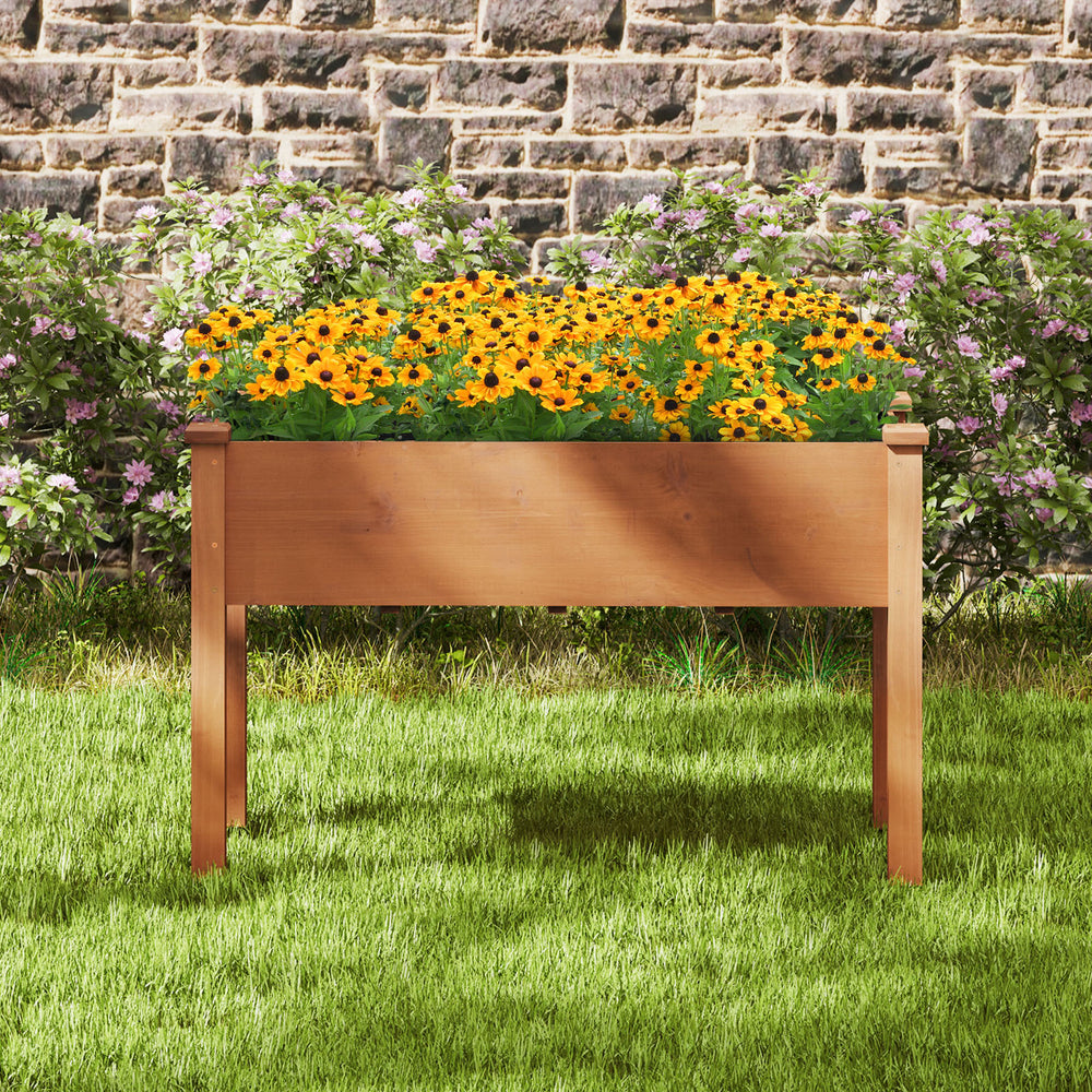 Raised garden bed with legs, crafted from natural wood, featuring drainage holes, ideal for flowers and herbs in the.