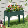 Elevated green metal gardening box with flowers, featuring drainage holes and a sturdy design for easy planting.