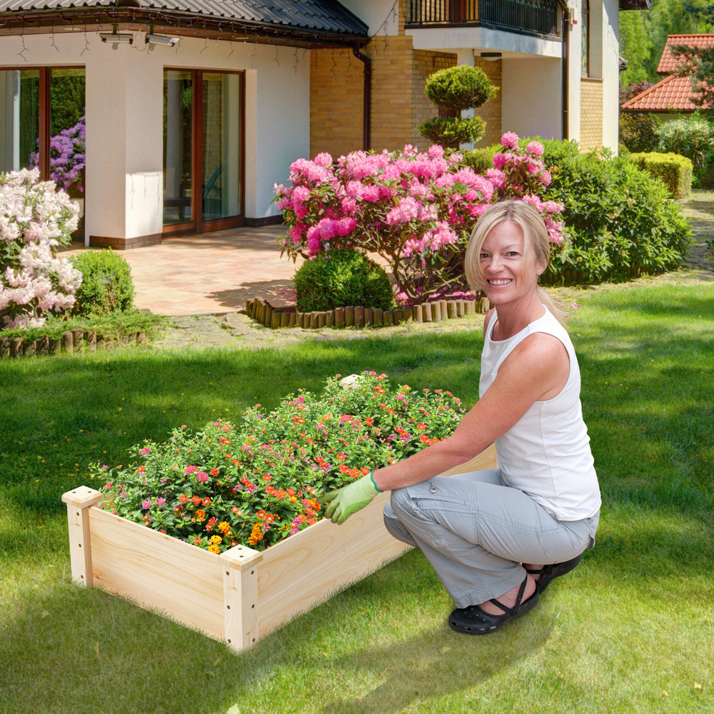 Raised garden bed made of fir wood, featuring vibrant flowers, ideal for versatile planting in your garden.