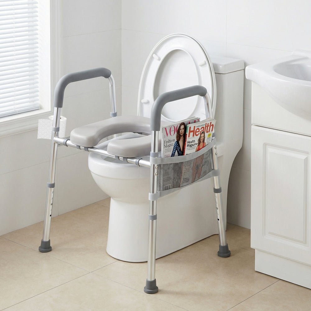 Raised toilet seat with handles and padded arms in silver, designed for seniors, featuring adjustable height and.