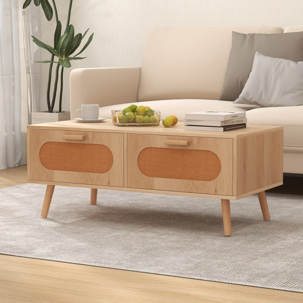 Mid-century modern rattan coffee table with two storage drawers, natural wood finish, perfect for living room.