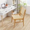 Rattan dining chair with natural cane backrest and teak wood frame, ideal for stylish indoor dining spaces.