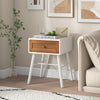 Mid-century modern rattan nightstand with a white finish and drawer, perfect for bedroom decor and storage.