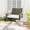 Single rattan porch swing with acacia wood armrests and white cushion, perfect for outdoor relaxation on the patio.
