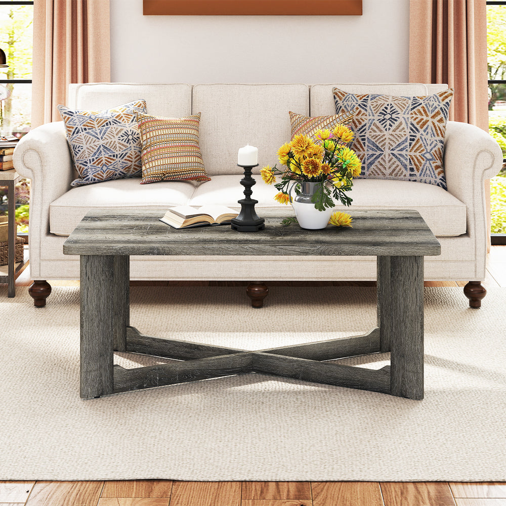Rectangle coffee table with gray rubber wood and X-shaped base, showcasing a spacious tabletop for easy access to.