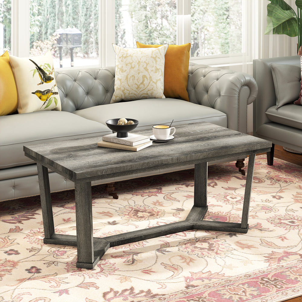 Rectangle coffee table showcasing a cross-shaped gray rubber wood base, perfect for enhancing living room decor.