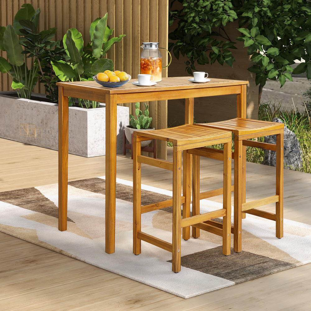 Rectangular acacia wood bar height table with two stools, perfect for outdoor dining and relaxation in the garden.