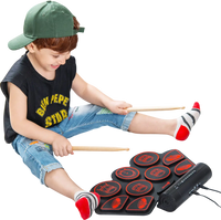 Child playing the Electronic Drum Set with built-in speakers, featuring 9 rhythms and 15 speeds for fun music practice.