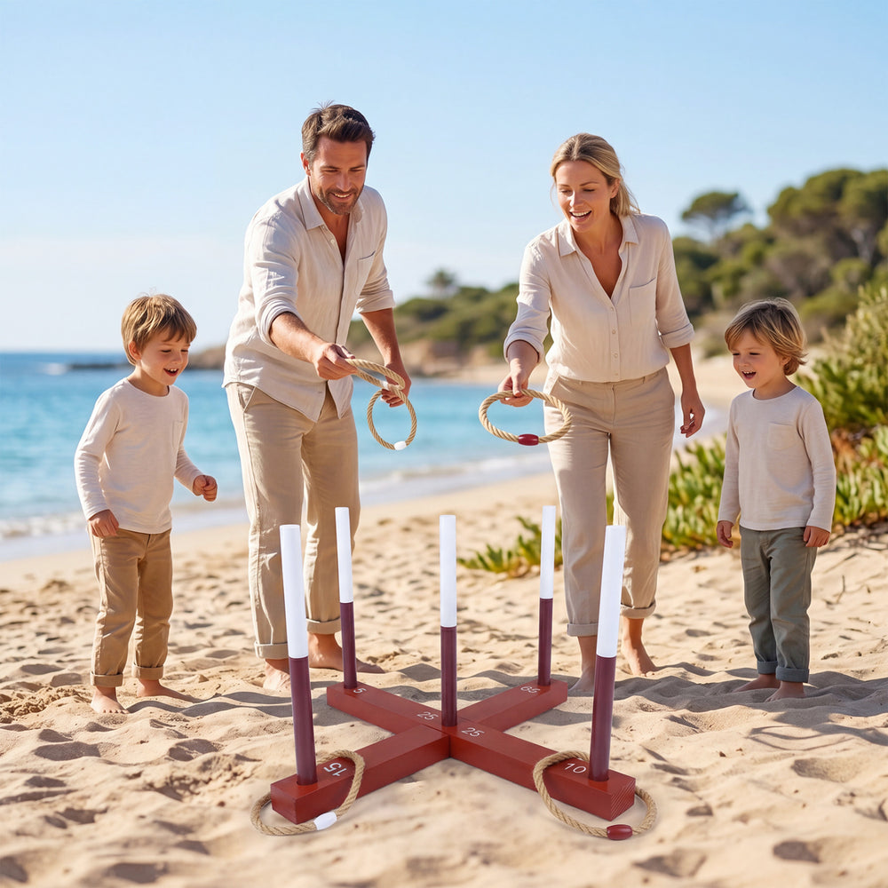 Family enjoying a Ring Toss Game on the beach with 6 rope rings and a durable brown wooden frame for outdoor fun.