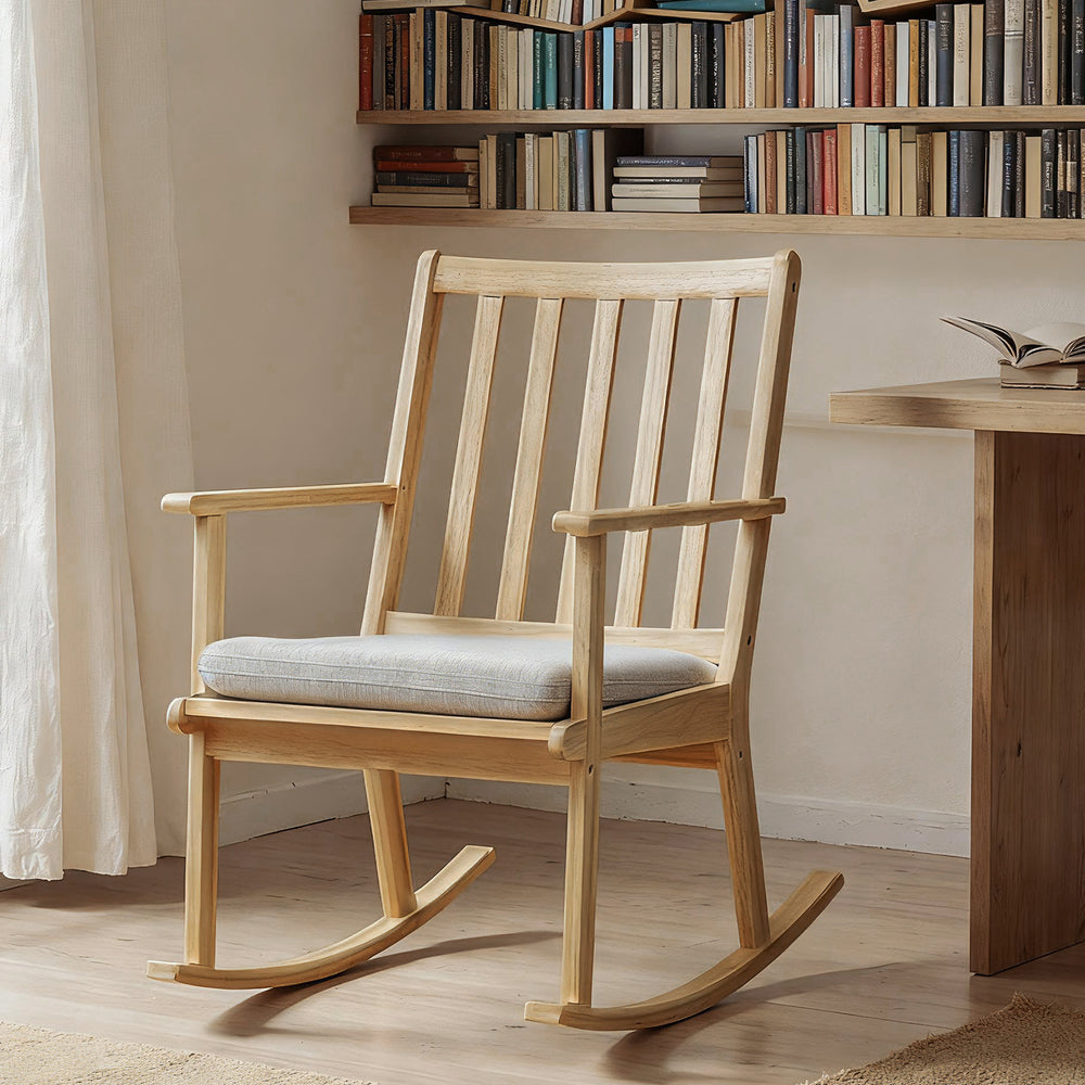 Natural solid rubber wood rocking chair with padded seat cushion, ideal for reading and relaxation in any home setting.