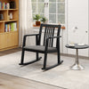 Black rocking chair showcasing a slatted back and soft linen seat, ideal for a cozy reading nook or quiet reflection.
