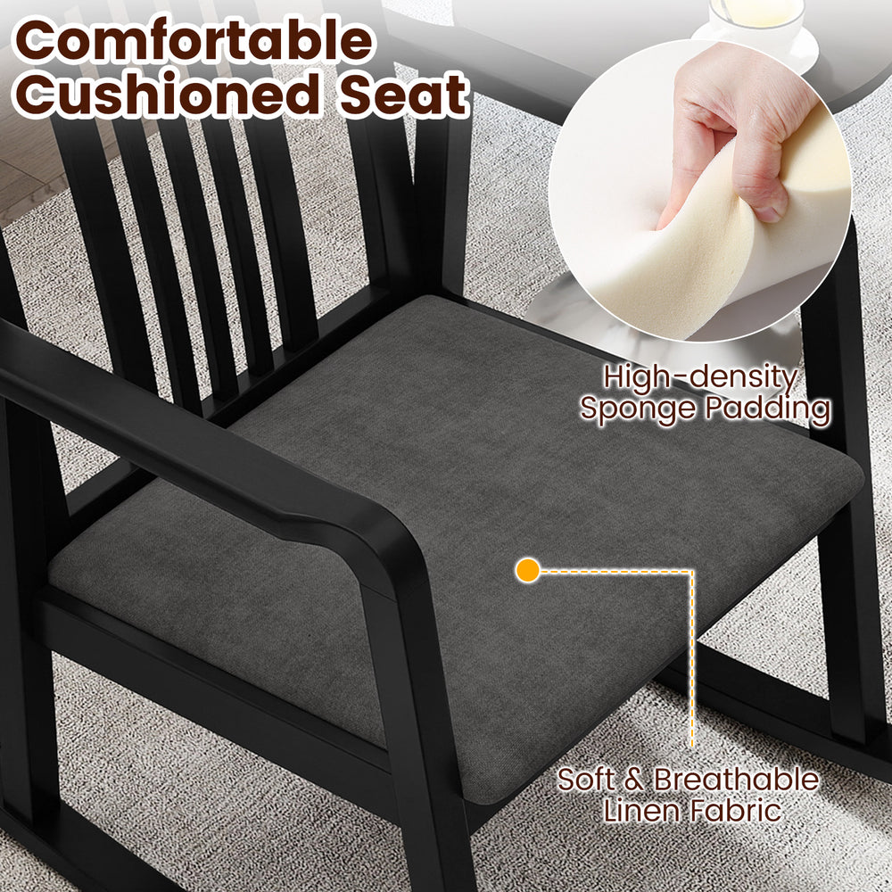 Cushioned seat of a black rocking chair featuring soft linen fabric and high-density sponge padding for comfort.