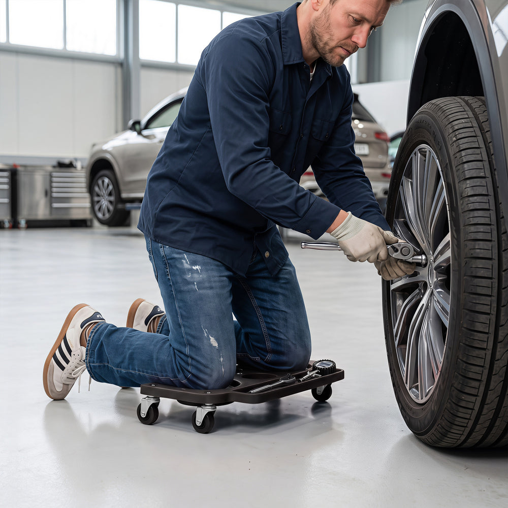 Rolling knee creeper with contoured EVA foam pads and 360° swivel casters for comfortable garage and repair tasks.
