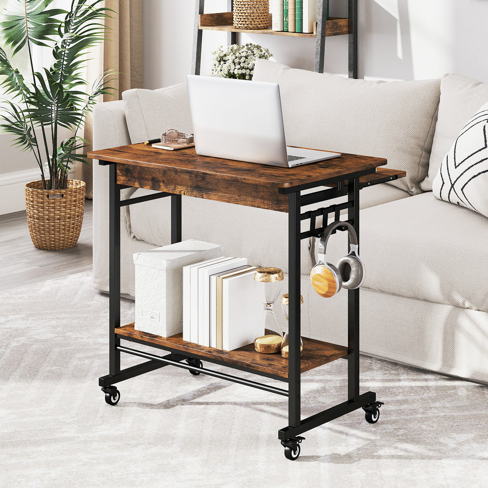 Rolling laptop table in rustic brown with a smooth surface, bottom shelf for storage, and durable construction for.