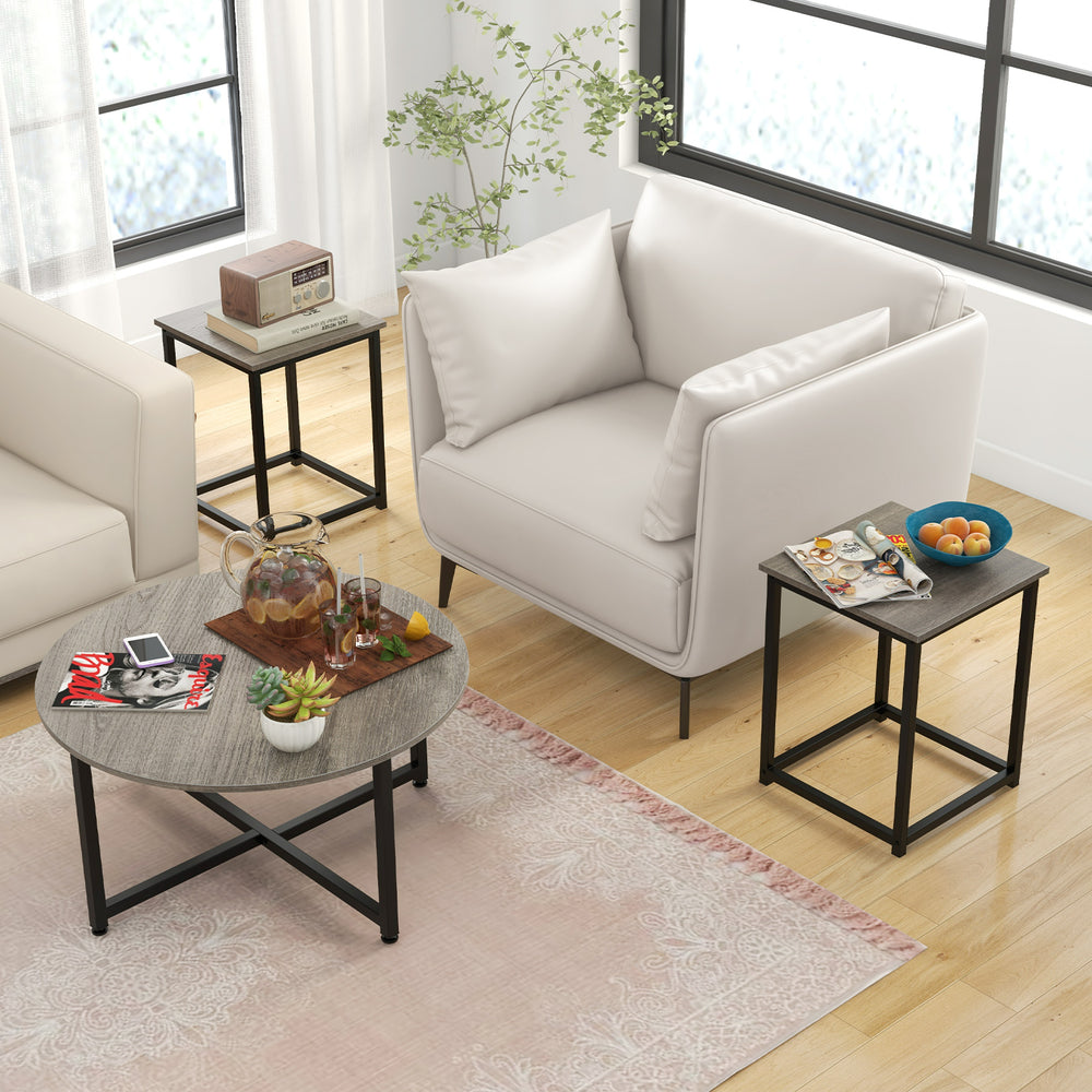 Round coffee table with gray textured surface and two square end tables, perfect for versatile living room layouts.