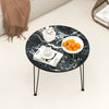 Round coffee table with a thickened black faux marble top, ideal for displaying fruit and magazines in modern interiors.