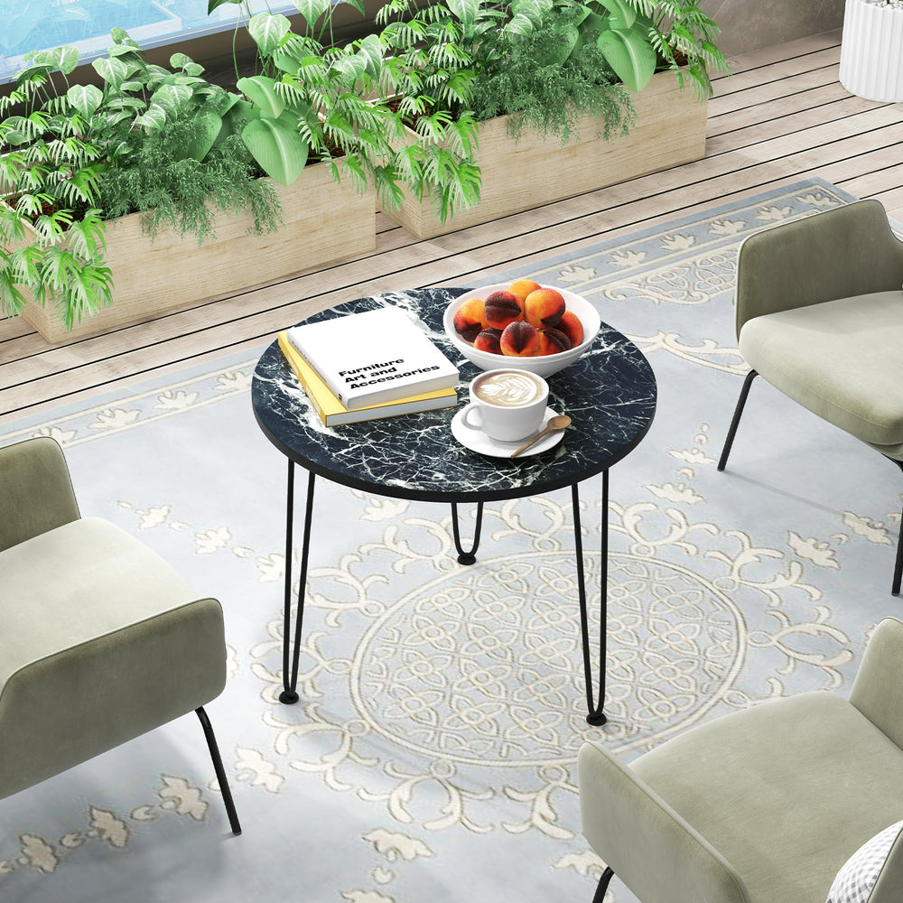 Round coffee table showcasing a thickened black faux marble surface and metal tripod legs, ideal for stylish small.