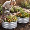 Round galvanized raised garden bed with vibrant flowers, featuring a spacious planting area and open-ended base for.