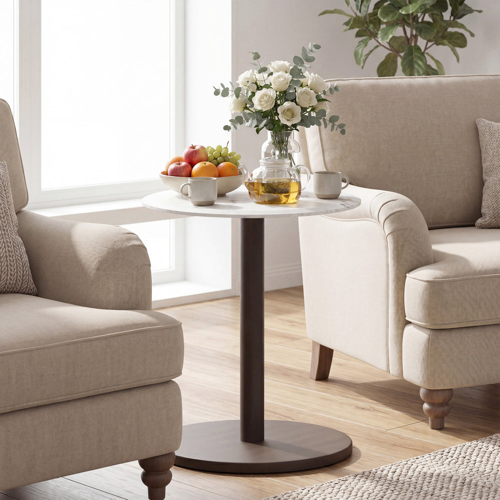 Round marble side table with a stone finish and wooden base, perfect for living room decor and beverage display.