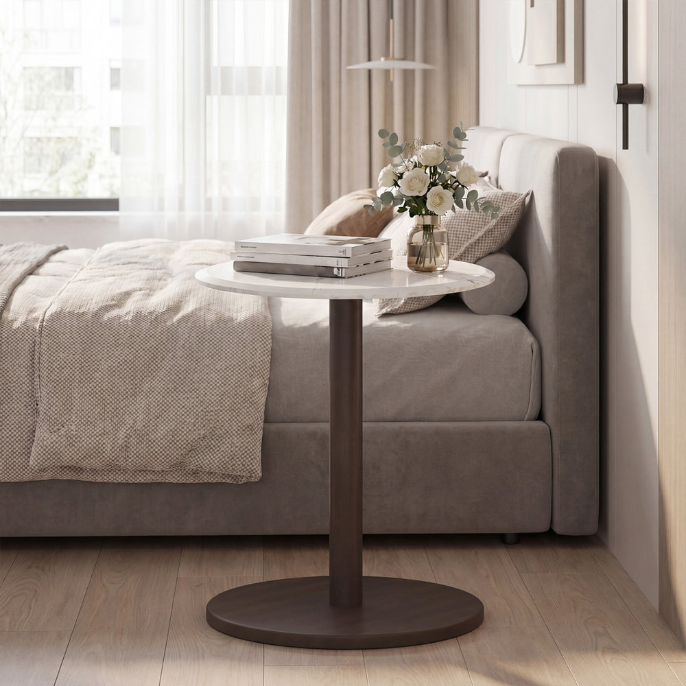 Round marble side table with a wooden base, featuring a stone finish, perfect for bedside use in modern decor.
