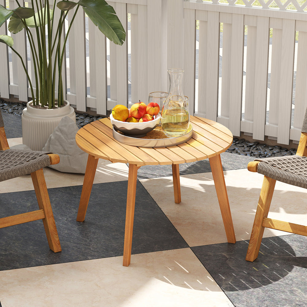 Round outdoor acacia wood side table with slatted tabletop, perfect for patio or garden use, featuring a natural finish.