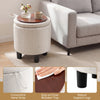 Round beige storage ottoman with a removable wooden tray, featuring a hand strap and robust support legs for stability.
