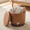 Round storage ottoman in brown faux leather with acacia wood frame, featuring 360° swivel and hidden storage for living.