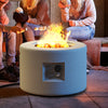 Round terrazzo propane gas fire pit with lava rocks, featuring a stylish white design for outdoor gatherings.