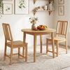 Natural rubber wood dining chairs set of 2 with ergonomic backrest, placed around a round dining table for cozy dining.