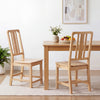Natural rubber wood dining chairs with hollowed backrest, showcasing ergonomic design and stability for dining comfort.