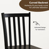 Curved backrest of a black wooden dining chair, designed for comfort and ventilation in a rustic kitchen setting.