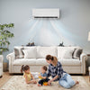 Mini split heat pump in a living room, providing efficient heating and cooling with remote control and inverter.