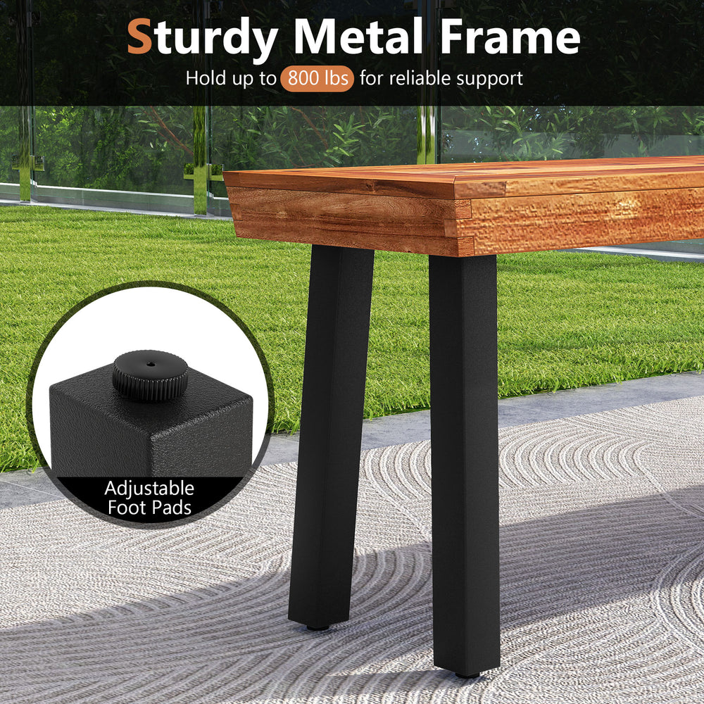 Close-up of the sturdy metal frame of the acacia wood bench, featuring adjustable foot pads for outdoor stability.