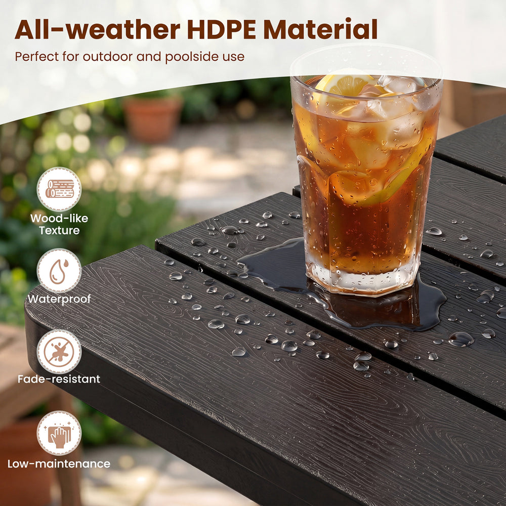 Black outdoor Adirondack side table with slatted surface, made of all-weather HDPE material for poolside use.