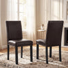 Two faux leather upholstered dining chairs with nailhead accents, featuring solid wood legs for kitchen or dining areas.