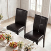 Two faux leather upholstered dining chairs with nailhead accents, featuring solid wood legs and a comfortable padded.