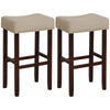Beige upholstered bar stools with solid rubber wood legs, featuring a curved padded seat and nailhead trim for dining.
