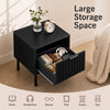 Black modern nightstand featuring a vertical-striped storage drawer and open shelf, ideal for compact bedside storage.