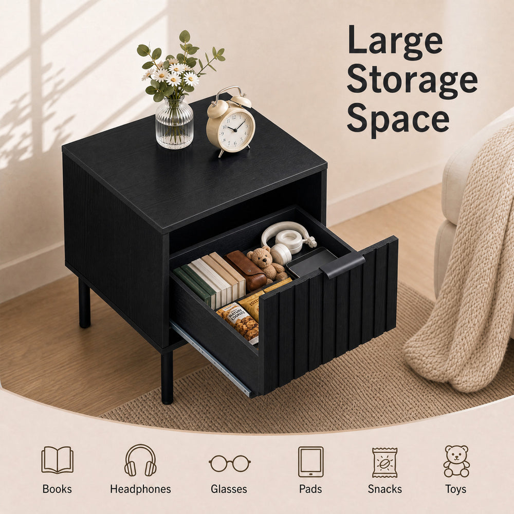 Black modern nightstand featuring a vertical-striped storage drawer and open shelf, ideal for compact bedside storage.