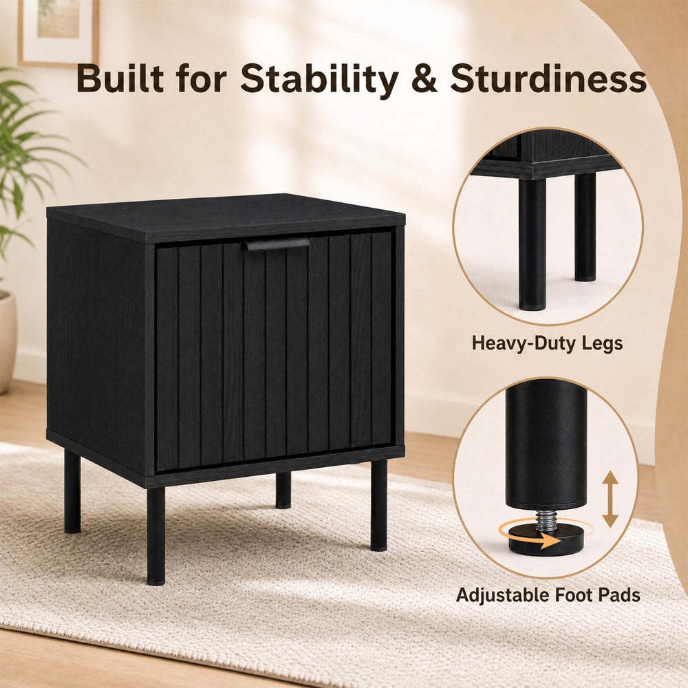 Black modern nightstand with vertical-striped storage drawer and adjustable foot pads for enhanced stability in small spaces.